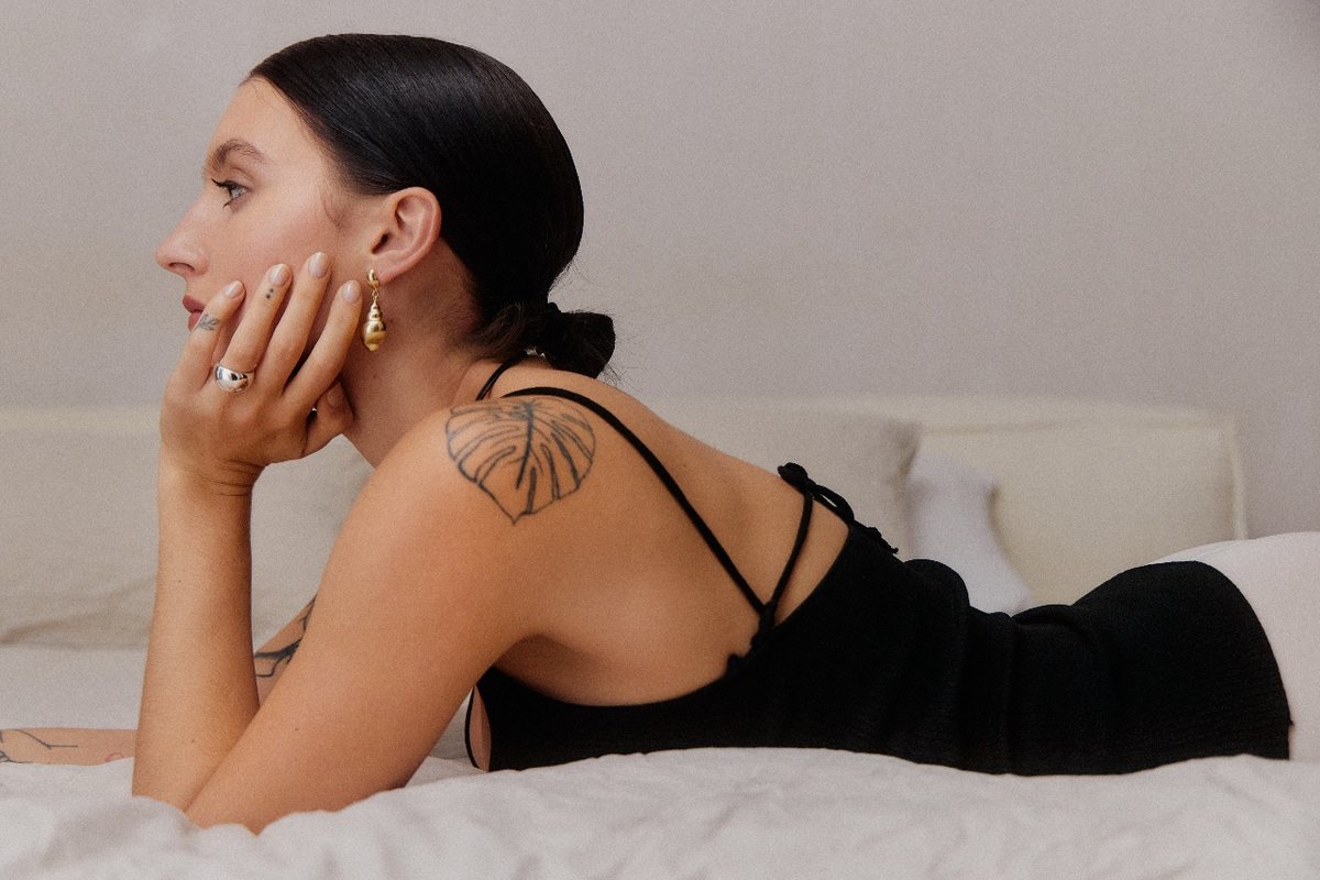 Creator wearing gold drop earrings