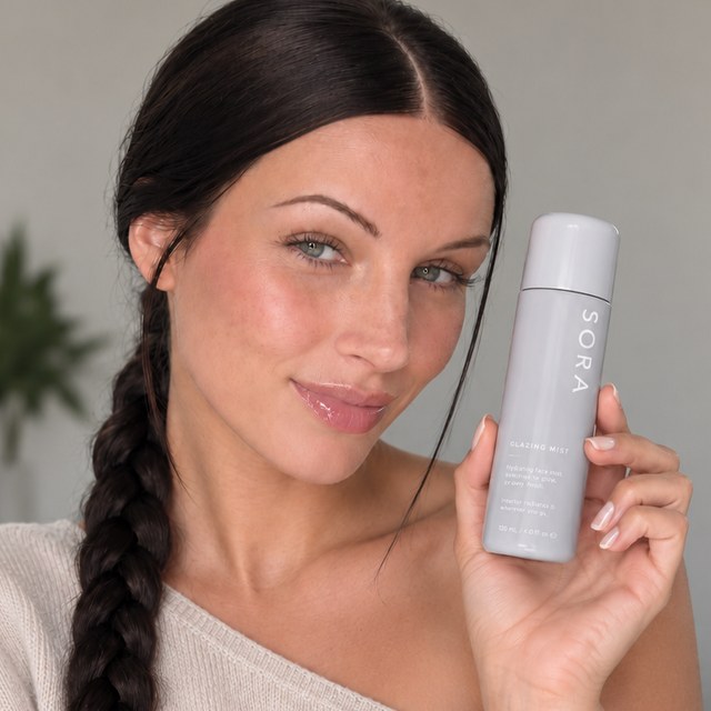 Creator Sophie holding a skincare product